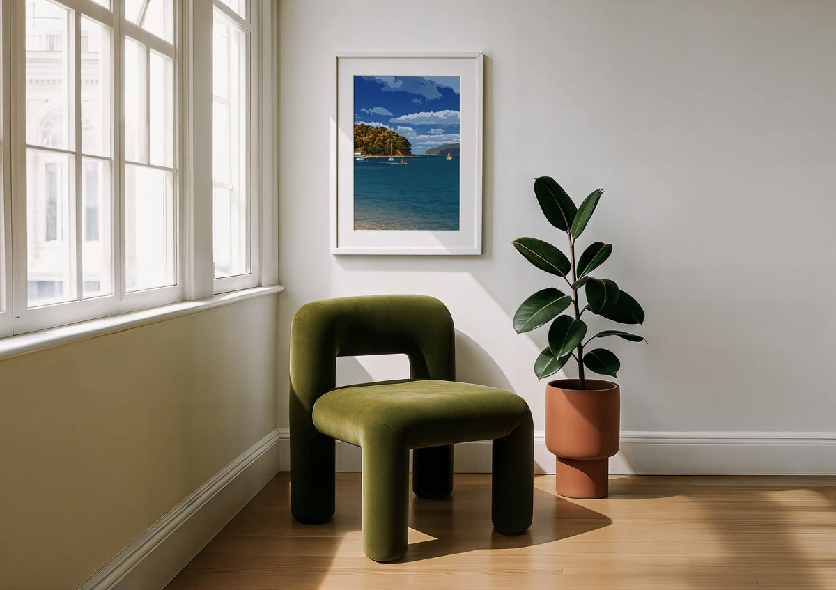 Bay Crossing print shown framed on a wall beside a green armchair