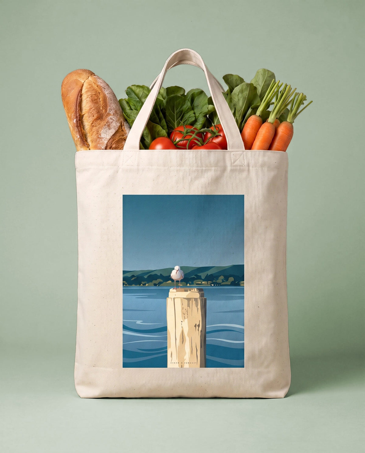 Coast & Compass Harbour Watch tote bag packed with fresh groceries against a teal studio backdrop, cream cotton canvas printed with the Harbour Watch artwork