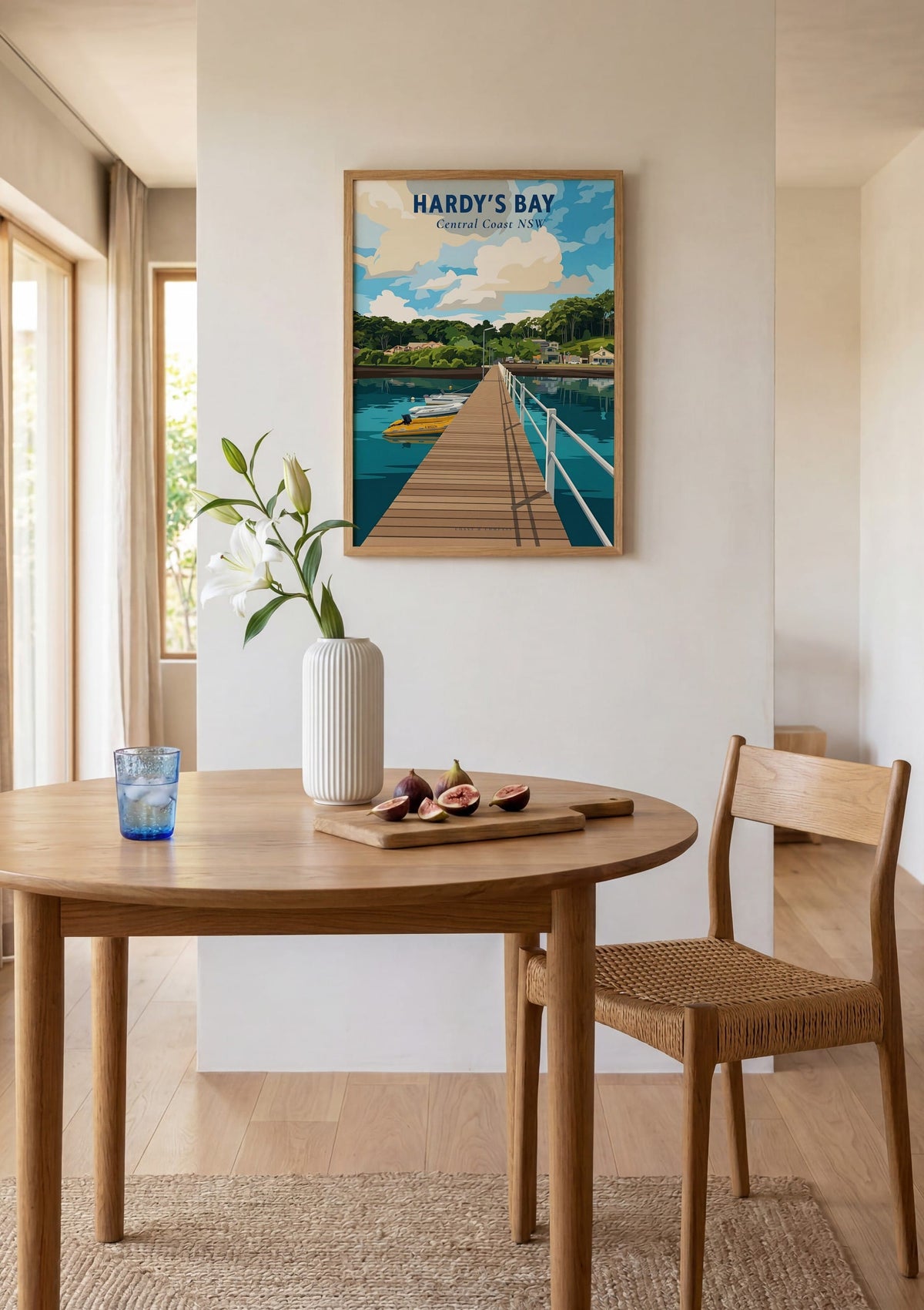 Hardy's Bay travel poster shown above a round dining table