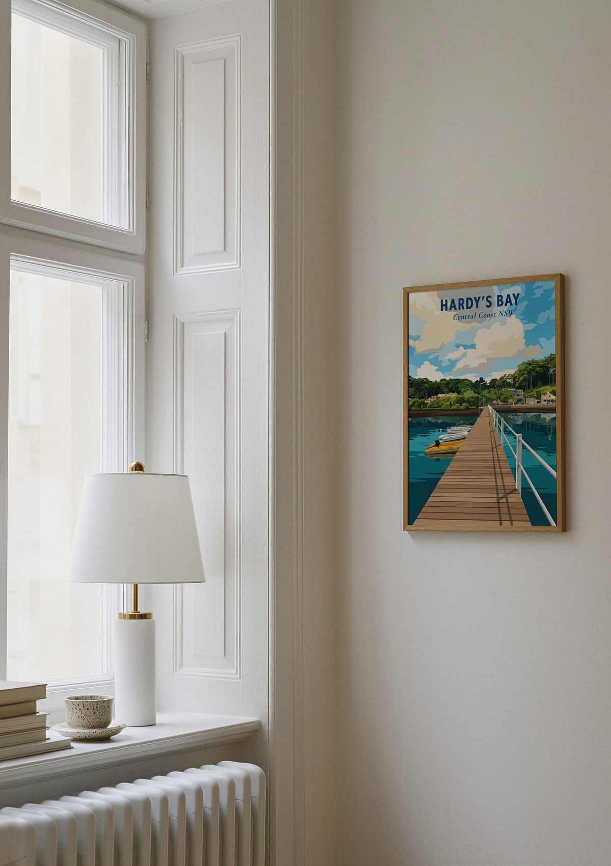 Hardy's Bay travel poster shown on a wall beside a window