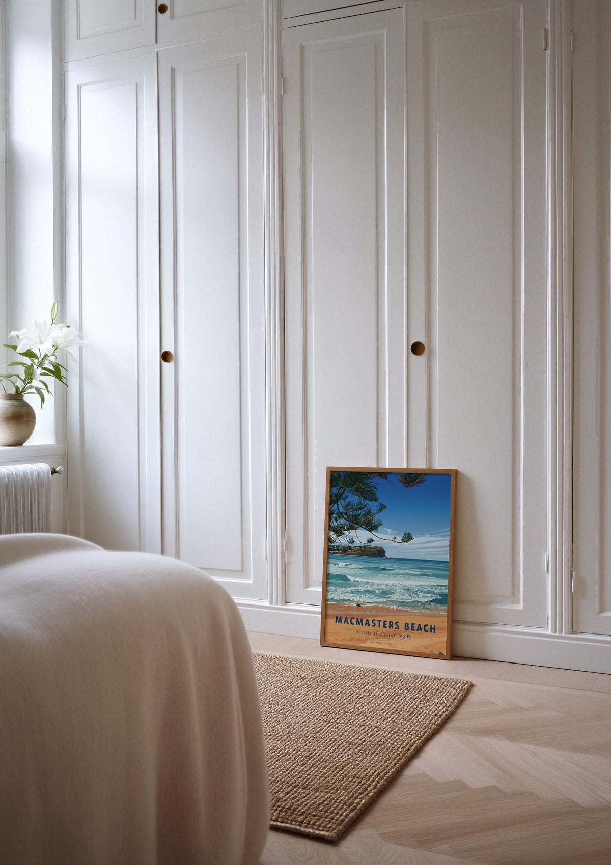 Macmasters Beach travel poster shown unframed, leaning against a wardrobe