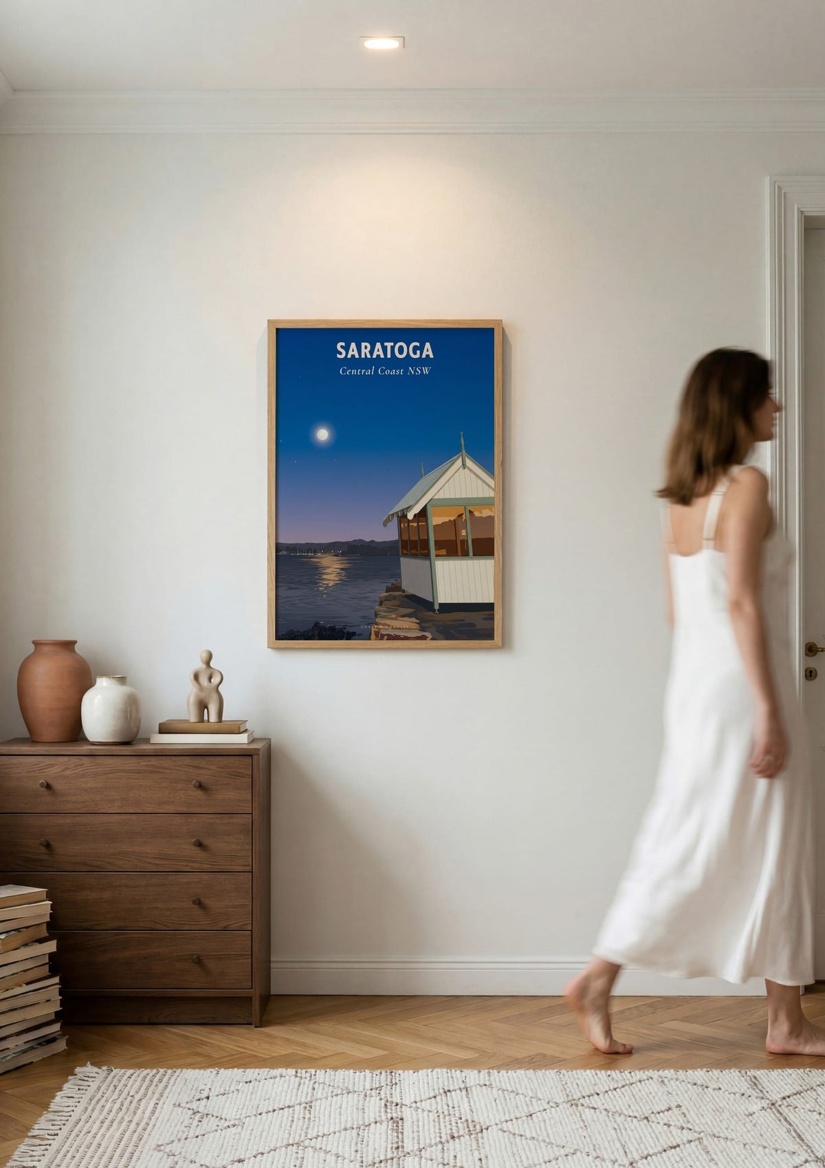 Saratoga travel poster shown on a wall as a woman walks past