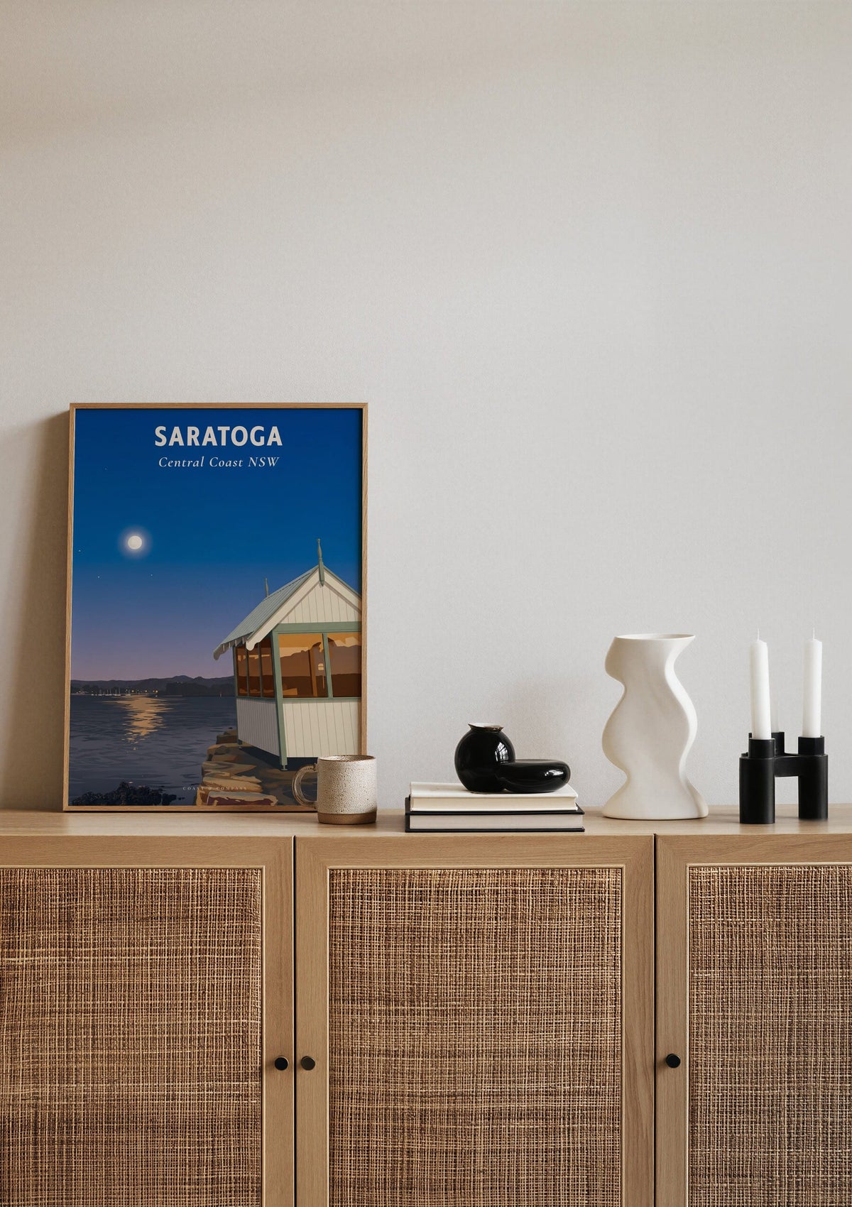 Saratoga travel poster shown resting on a sideboard