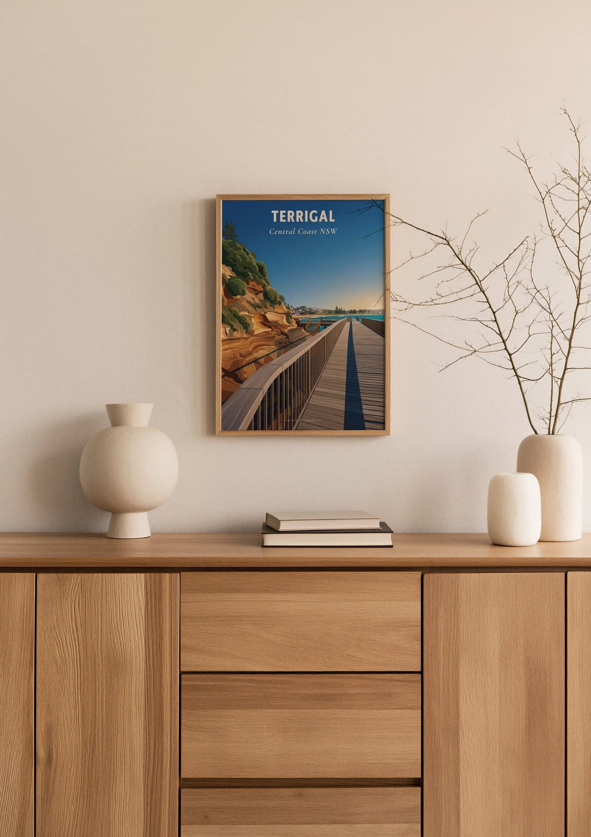 Terrigal Boardwalk travel poster shown at A3 size above a sideboard with a branch in a vase