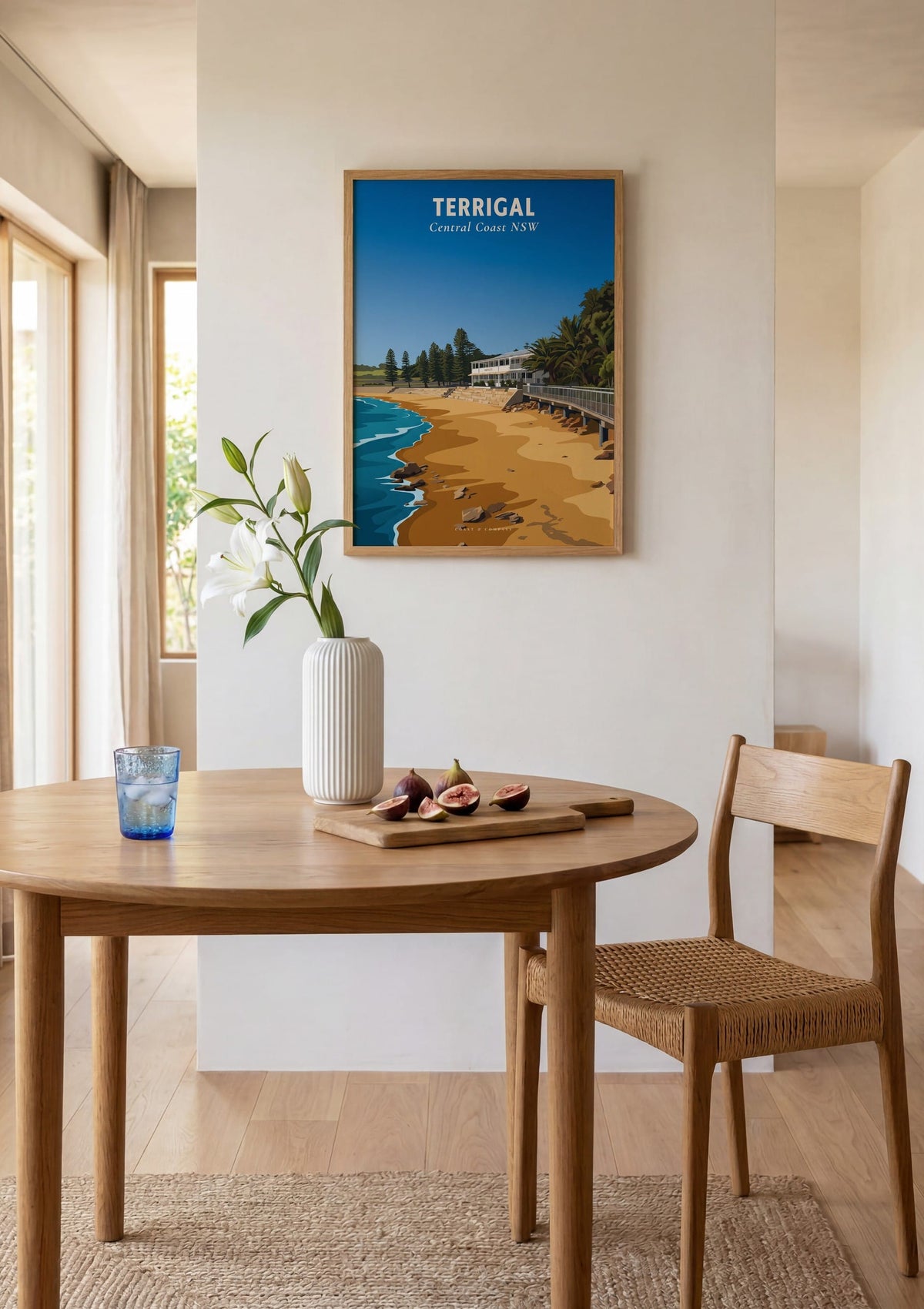 Terrigal Haven Beach travel poster shown above a round dining table