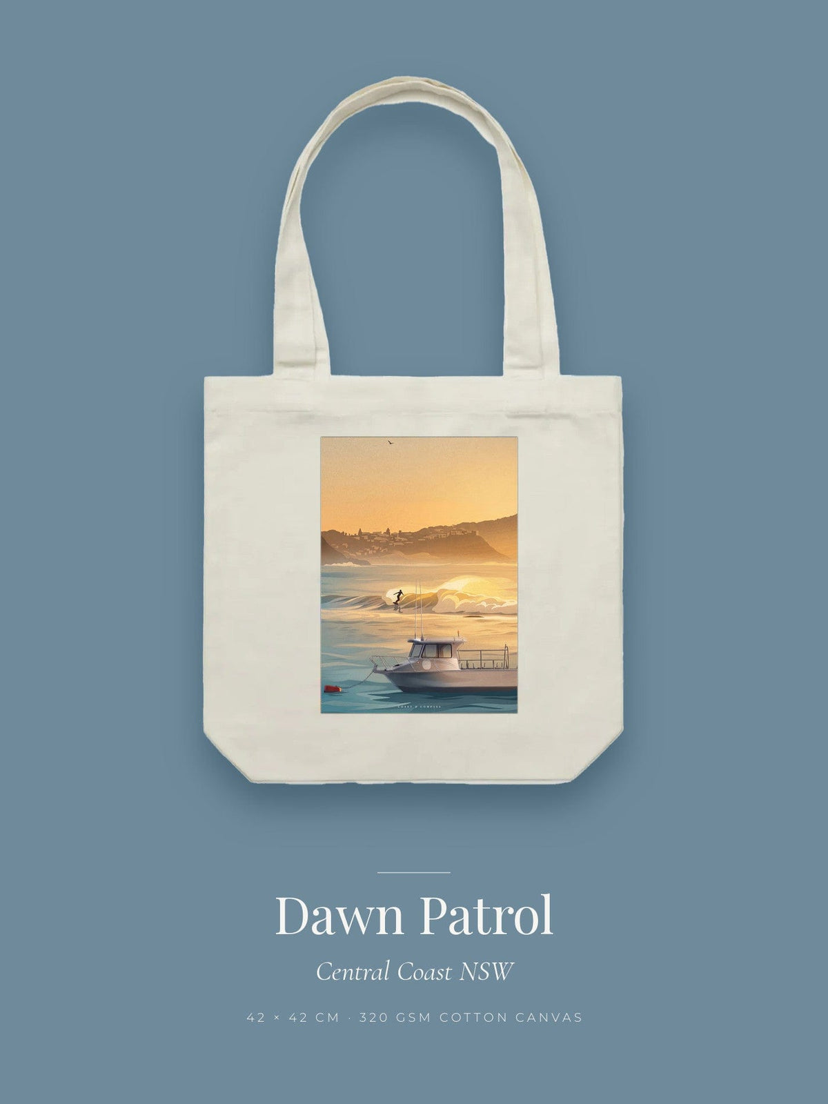 Dawn Patrol artwork printed on a cream cotton canvas tote bag — a surfer on a golden wave with a moored boat in the foreground