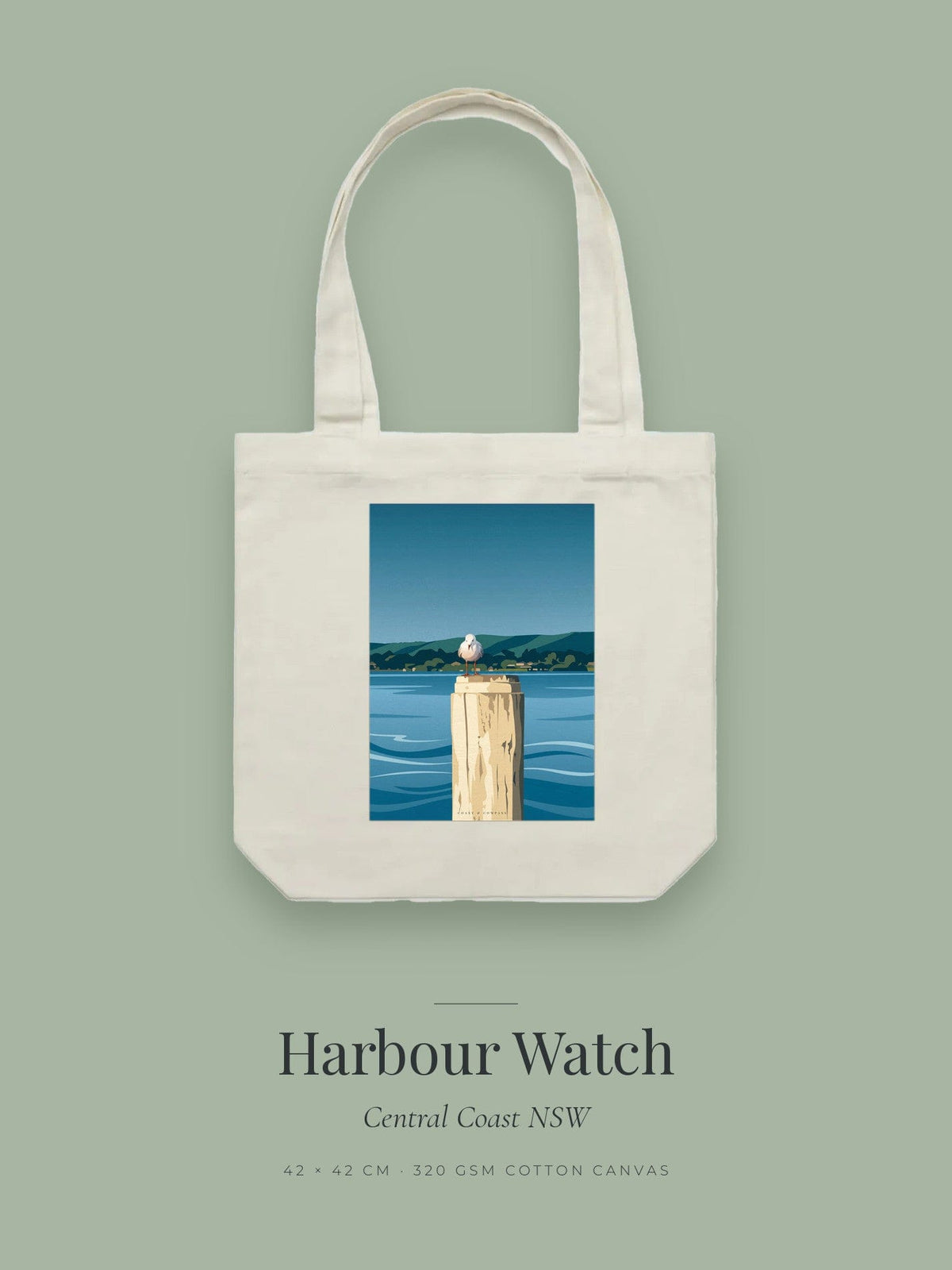 Harbour Watch artwork printed on a cream cotton canvas tote bag — a seagull perched on a timber pylon above still water