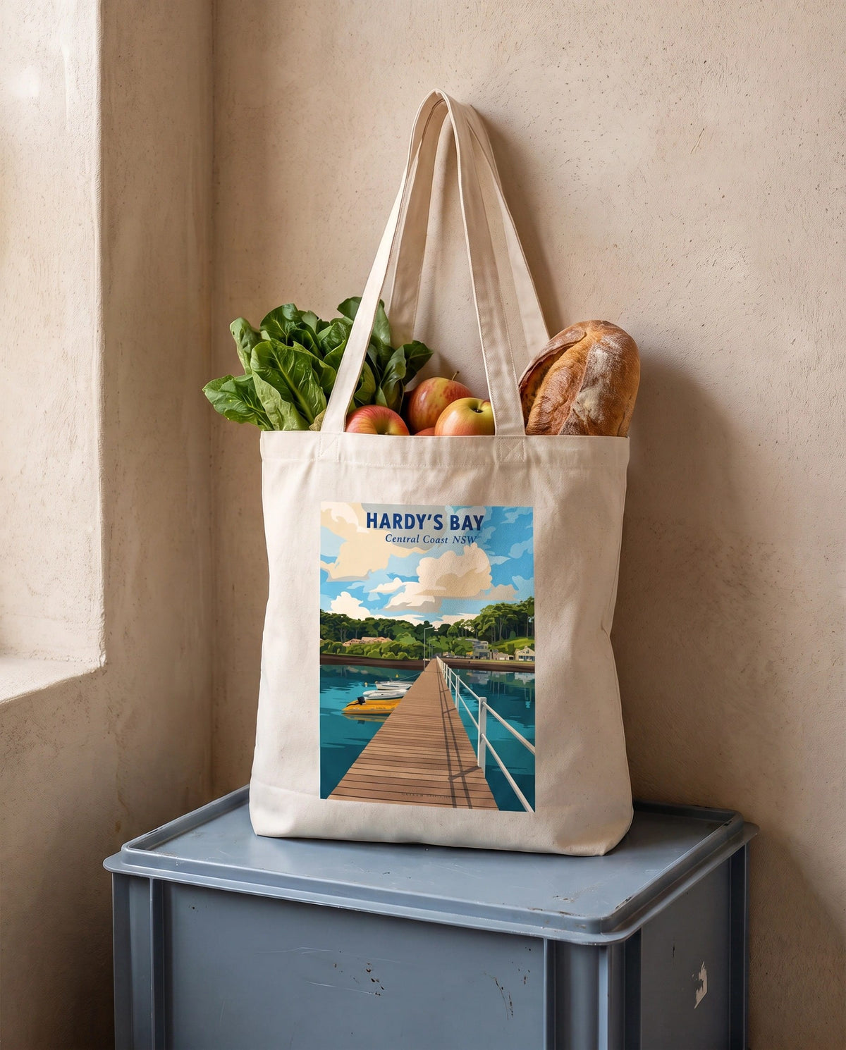 Coast & Compass Hardy's Bay tote bag packed with fresh groceries, cream cotton canvas printed with the Hardy's Bay Central Coast NSW poster design