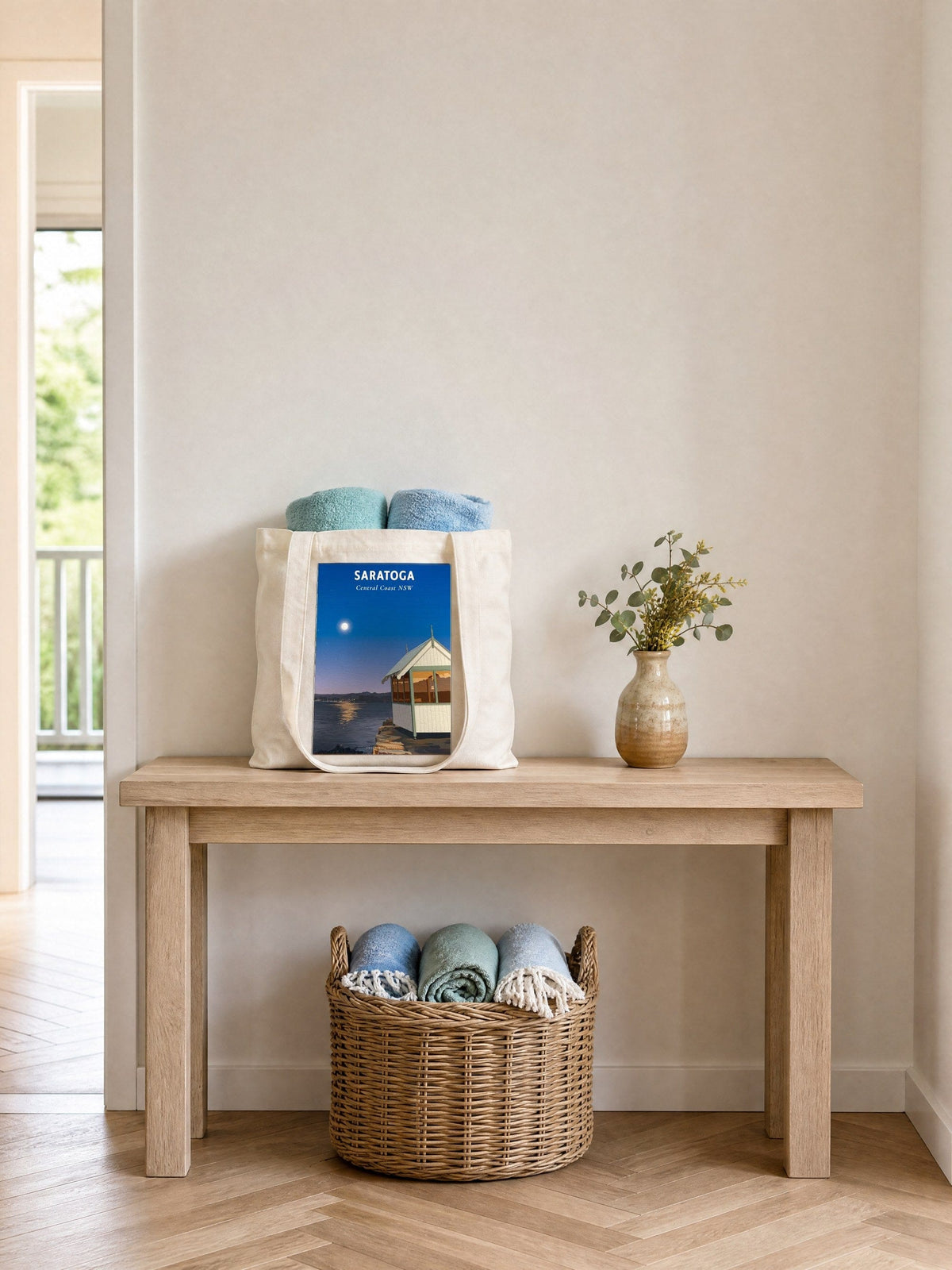 Coast & Compass Saratoga tote bag on a timber hall console with rolled beach towels, printed cotton canvas