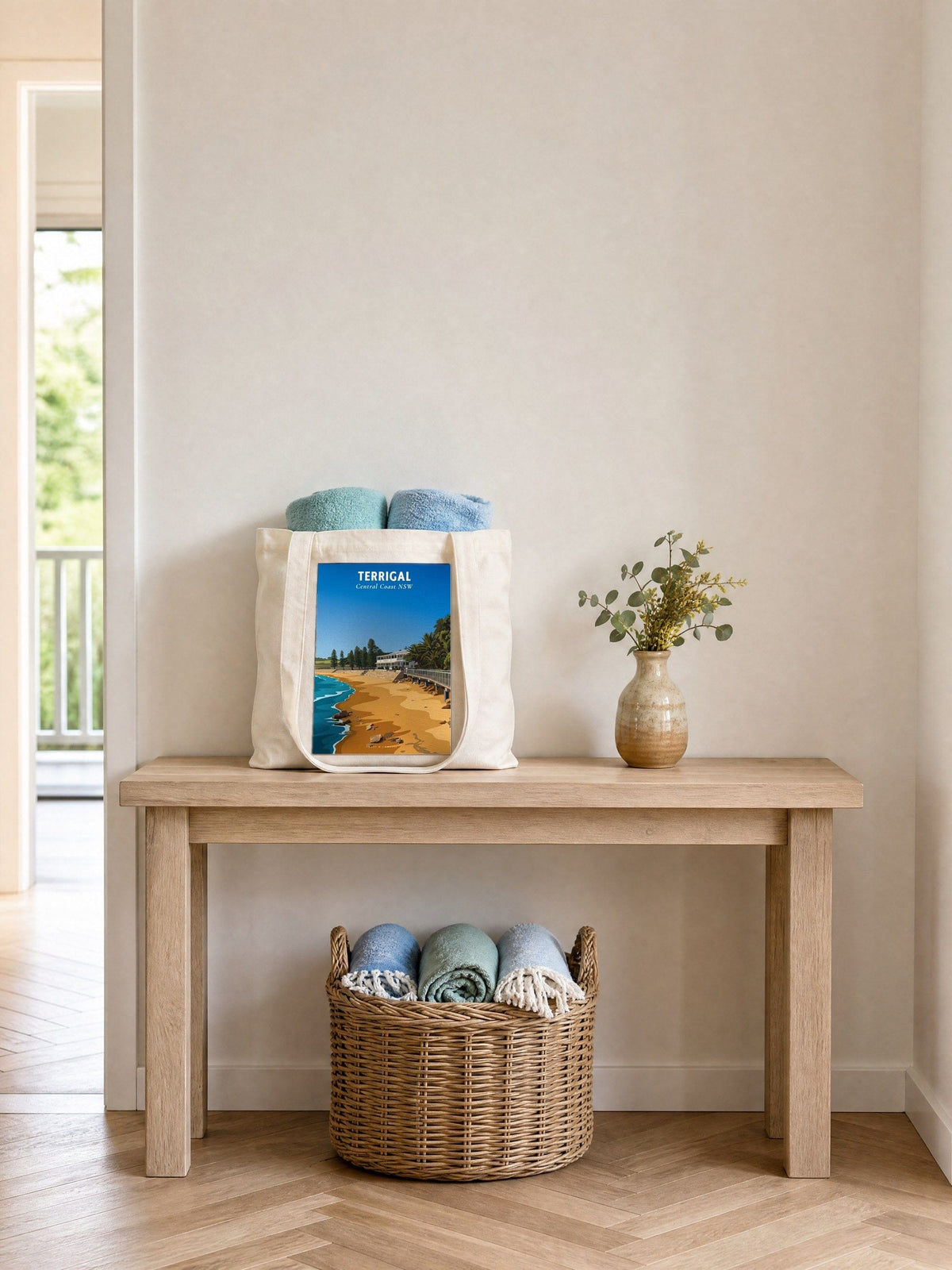 Coast & Compass Terrigal Haven tote bag on a timber hall console with rolled beach towels, printed cotton canvas