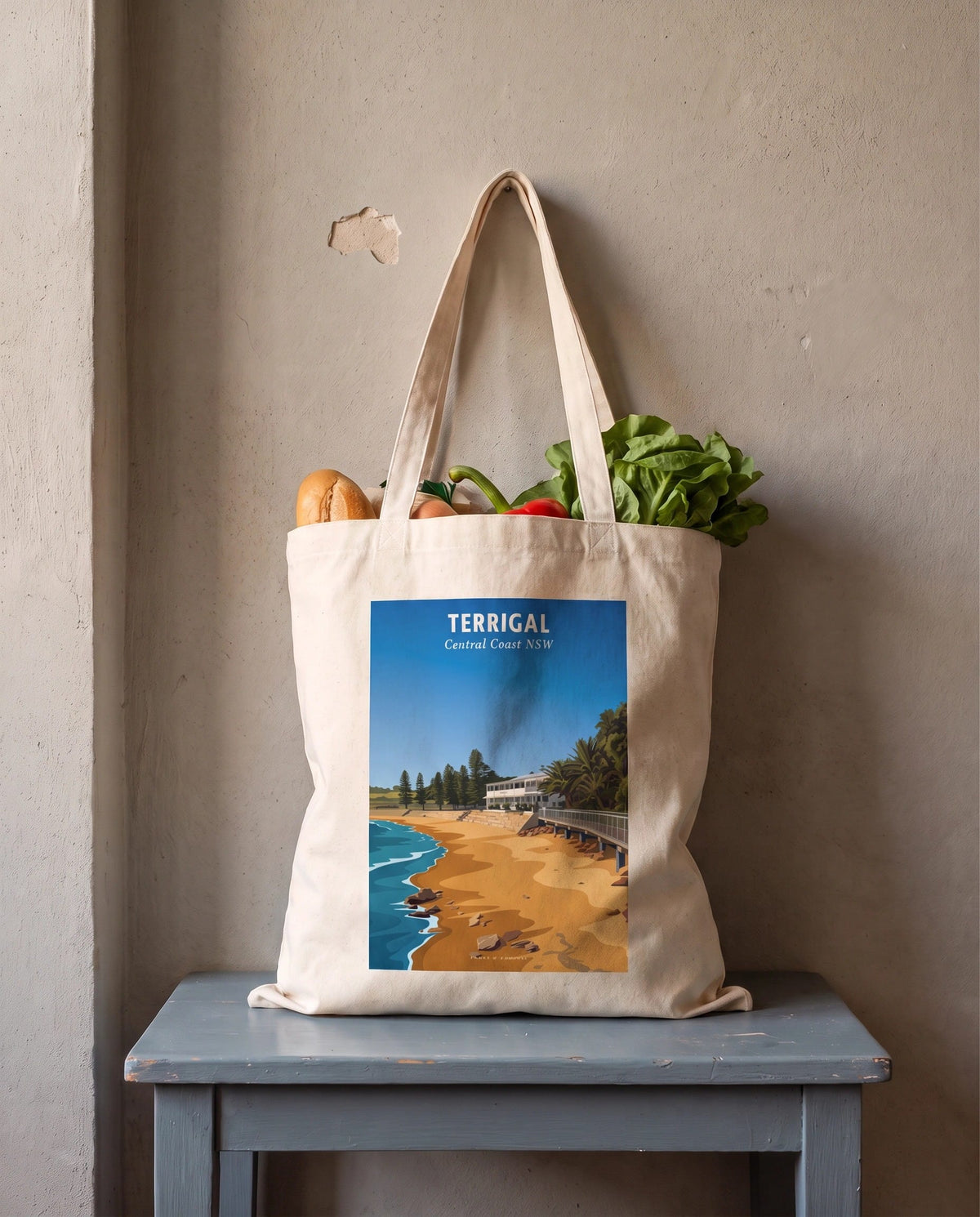 Coast & Compass Terrigal Haven tote bag packed with fresh groceries, cream cotton canvas printed with the Terrigal Haven Central Coast NSW poster design