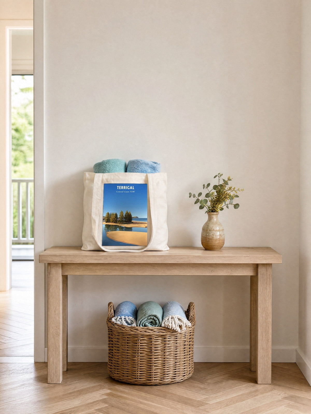 Coast & Compass Terrigal Pines tote bag on a timber hall console with rolled beach towels, printed cotton canvas